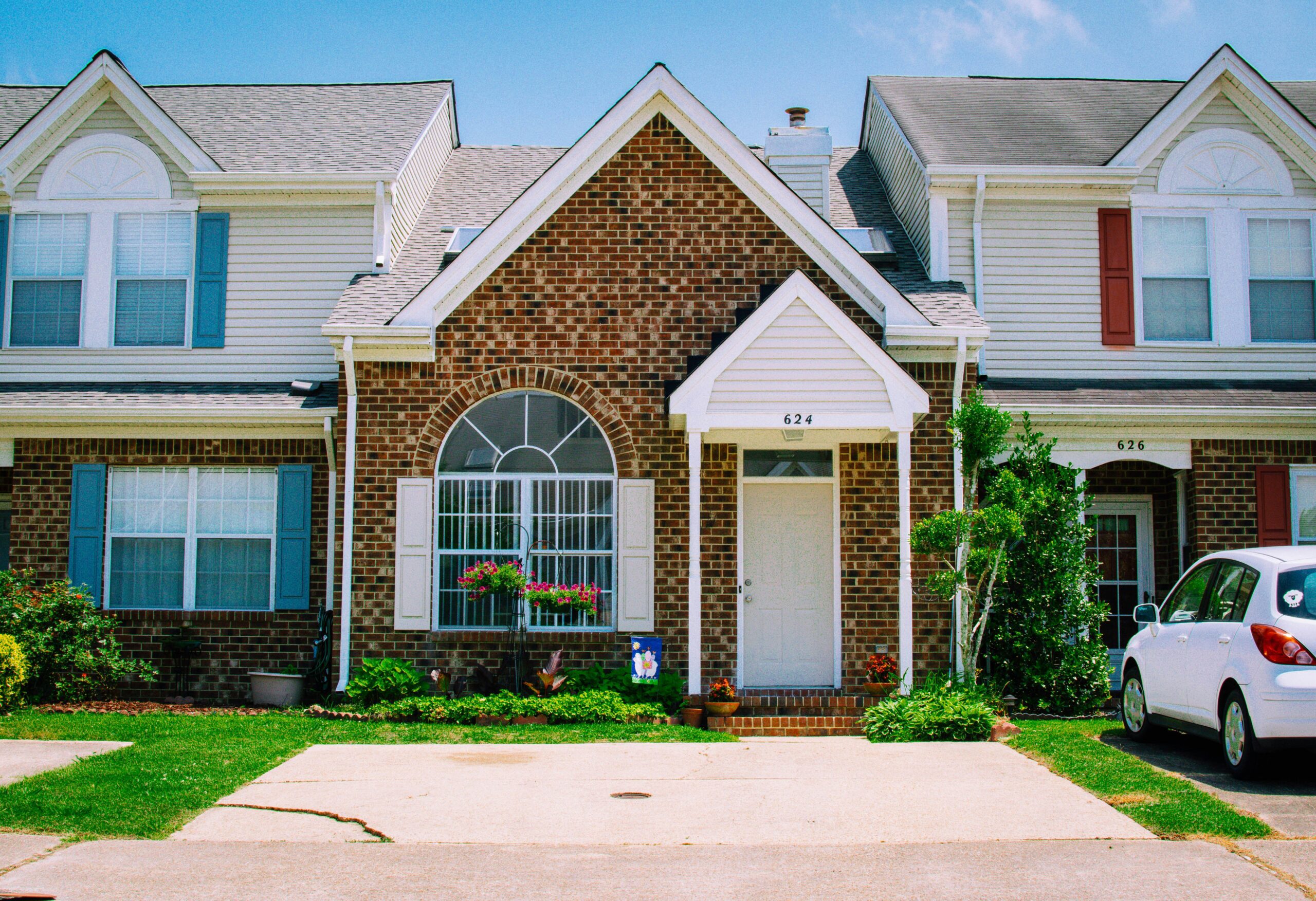 Front of a brick house representing house sitting services rates